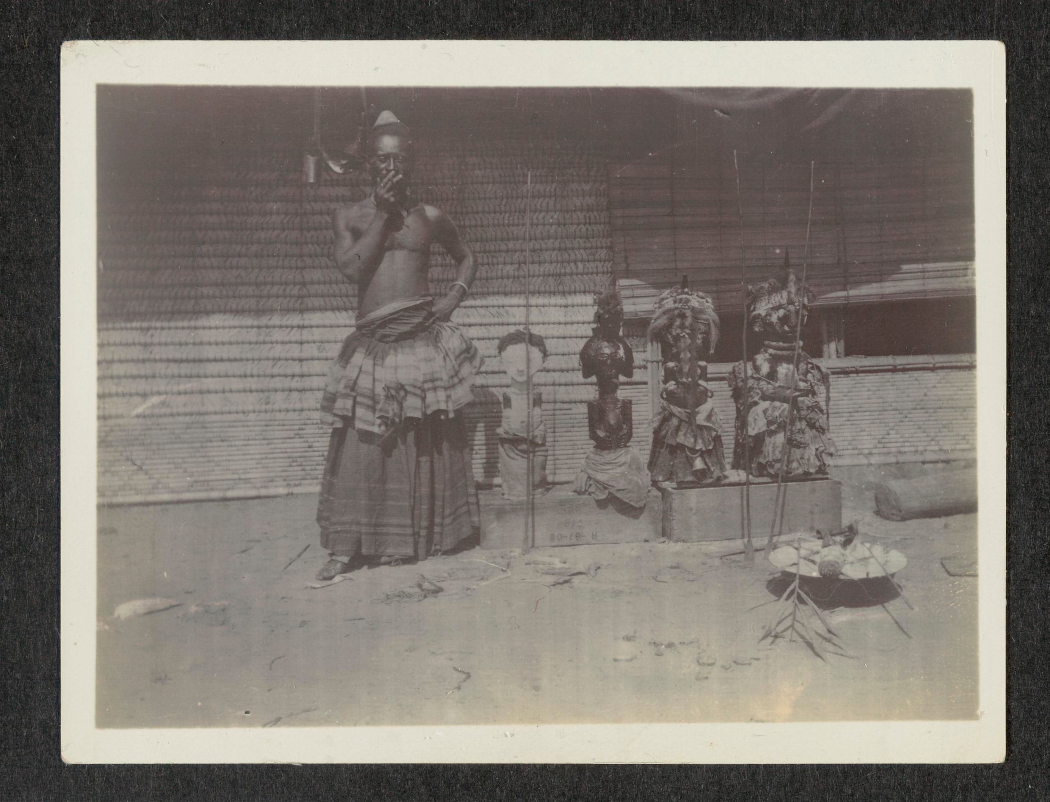 Kuba King Kot aPe standing next to four Songye sculptures