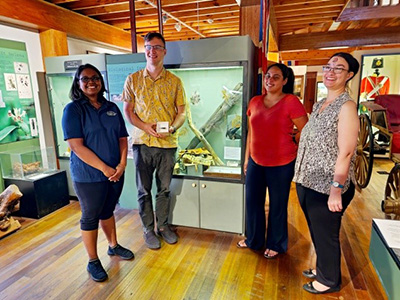 group of people with the earwig specimen